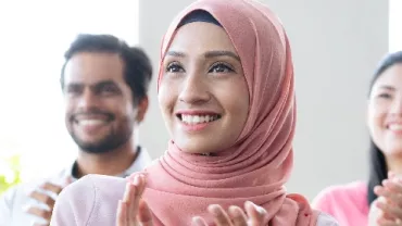 Two women and a man in an office setting