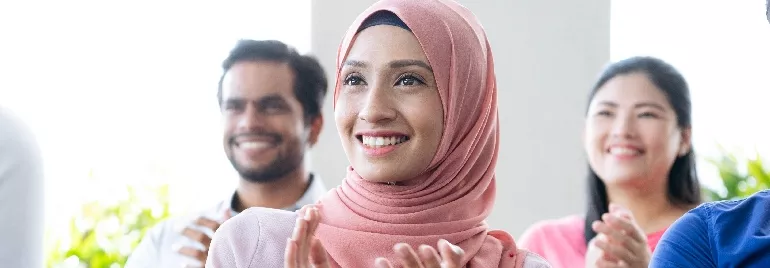 Two women and a man in an office setting