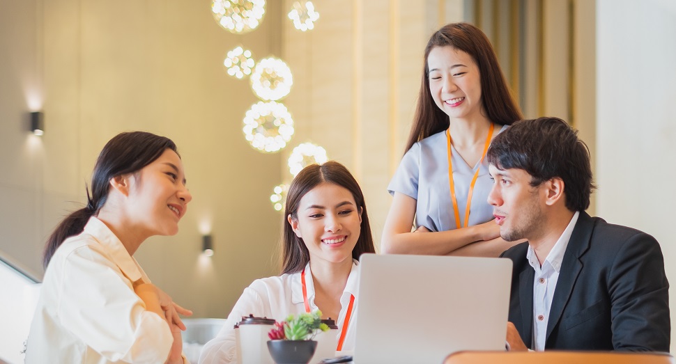 3 women and 1 man in a work discussion